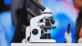 White microscope standing on a table in science lab Royalty Free Stock Photo