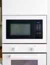 White microwave oven in modern scandi kitchen Royalty Free Stock Photo