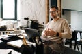 White middle-aged man heaving meeting on a laptop computer in office