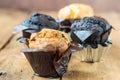 White milk and chocolate baked muffins - wooden background