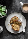 White and milk chocolate banana oatmeal cake, coffee, succulent flower on a dark table background, top view. Delicious breakfast, Royalty Free Stock Photo