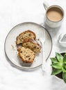 White and milk chocolate banana oatmeal cake, coffee, succulent flower on a light table background, top view. Delicious breakfast Royalty Free Stock Photo