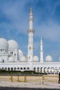 White Minaret of  Grand Mosque against blue sky, also called Sheikh Zayed BinSultan Nahyan Mosque, inspired by Persian, Mughal and Royalty Free Stock Photo