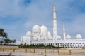 White Minaret of  Grand Mosque against blue sky, also called Sheikh Zayed BinSultan Nahyan Mosque, inspired by Persian, Mughal and Royalty Free Stock Photo