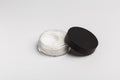 White mineral makeup in container, powder isolated on white background