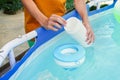 White mini chlorine tablet in the hand of a service worker for disinfection of swimming pools. The beginning of the Royalty Free Stock Photo