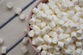 White Mini Marshmallows in a Pink Bowl, overhead view. Flat lay, top view, from above. Copy space Royalty Free Stock Photo