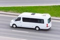 White minibus goes on the city highway street Royalty Free Stock Photo