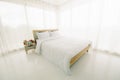 White minimalist bedroom interior at morning with sunlight