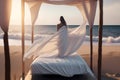 white minimalistic canopy bed with girl on the beach