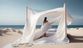 white minimalistic canopy bed with girl on the beach