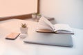 White minimalistic desk near a window with a lot of space fot te