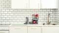 White minimalistic kitchen interior and design. Tile wall background. Household appliances - blender, vacuum machine Royalty Free Stock Photo