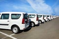 White minivans for sale in the parking lot. Cars in the parking lot in row Royalty Free Stock Photo