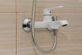 White mixer with hose on the wall