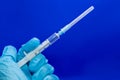 White 2 ml syringe macro in hand in blue glove Royalty Free Stock Photo