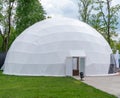 White mobile dome design. Outside spherical glamping dome. Hemispherical structure lattice shell geodesic polyhedron Royalty Free Stock Photo