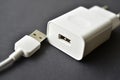 White mobile phone charger on black background Royalty Free Stock Photo