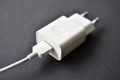 White mobile phone charger on black background Royalty Free Stock Photo