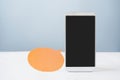 White mobile phone with clipping path on touchscreen and orange speech bubble, new normal lifestyle , home isolation