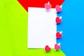White mockup blank decorative with hearts on geometric green, blue and red background. Royalty Free Stock Photo