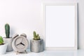 White mockup frame with cactuses and a round concrete clock Royalty Free Stock Photo