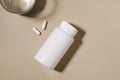 White mockup jar of pills and glass of water on beige isolated background. Concept of pharmacy, medicine, health care, daily Royalty Free Stock Photo