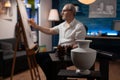 White model vase on wooden table used for light study by retired man artist drawing using sharp pencil Royalty Free Stock Photo