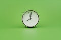 modern alarm clock on a light green background. Time concept and working with precious time Royalty Free Stock Photo