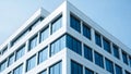 White modern building facade with blue glass windows against clear sky architecture Royalty Free Stock Photo
