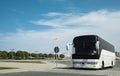 White Modern comfortable tourist bus driving through highway. Travel and coach tourism concept. Trip journey by vehicle Royalty Free Stock Photo