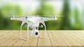 White modern drone on wooden table on background of nature