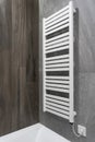 White and modern heated towel rail in bathroom Royalty Free Stock Photo