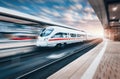 White modern high speed train in motion on railway station at su Royalty Free Stock Photo