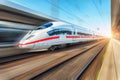 White modern high speed train in motion on railway station Royalty Free Stock Photo