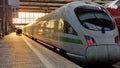 White modern high speed train on railway station at sunset Royalty Free Stock Photo