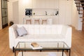 White modern home interior with loft kitchen and white leather sofa. Soft selective focus Royalty Free Stock Photo