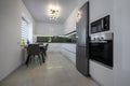 White modern kitchen with granite counter top and marble floor Royalty Free Stock Photo