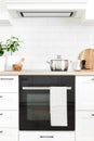 White modern kitchen interior with wooden worktop and kitchenware, culinary concept Royalty Free Stock Photo