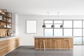 White modern kitchen near window. dining area with wooden countertop. Concrete floor. Panoramic windows. Mock up poster on wall Royalty Free Stock Photo