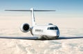 White modern luxury business jet flies in the air above the clouds. Close-up view corporate airplane