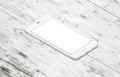 White modern mobile phone on table. Isometric, side position Royalty Free Stock Photo