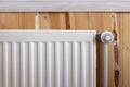 White modern radiator  in room with wooden wall and cozy interior Royalty Free Stock Photo