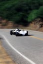 White modern sport car is driving on empty countryside asphalt road at sunset Royalty Free Stock Photo