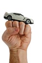 White modern supersport car toy model on a raised man fist, white background Royalty Free Stock Photo