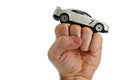 White modern supersport car toy model on a raised man fist, white background Royalty Free Stock Photo