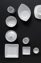 White, modern tableware in various designs on a black background Royalty Free Stock Photo