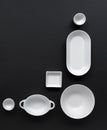 White, modern tableware in various designs on a black background Royalty Free Stock Photo