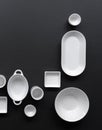 White, modern tableware in various designs on a black background Royalty Free Stock Photo