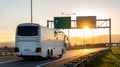 White Modern tourist bus at sunset Royalty Free Stock Photo